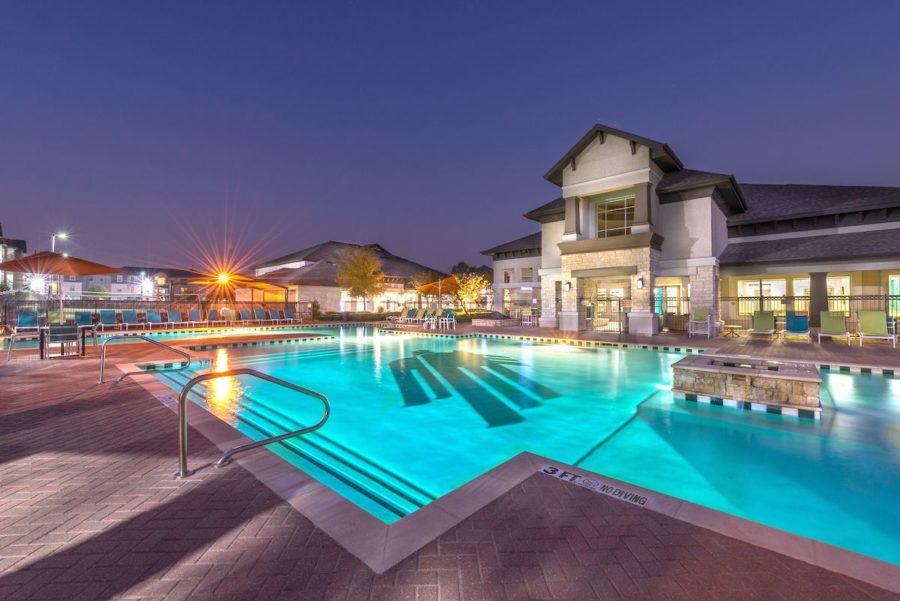 outdoor pool area during nighttime at forum at denton station apartments