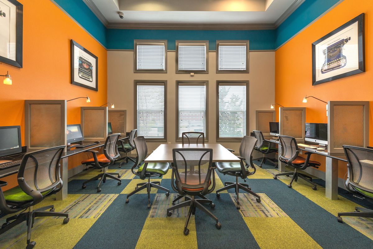 common room with computers inside forum at denton station apartments