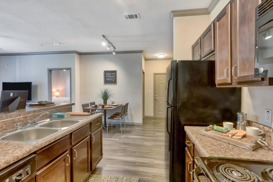 fully furnished kitchen inside forum at denton station apartments