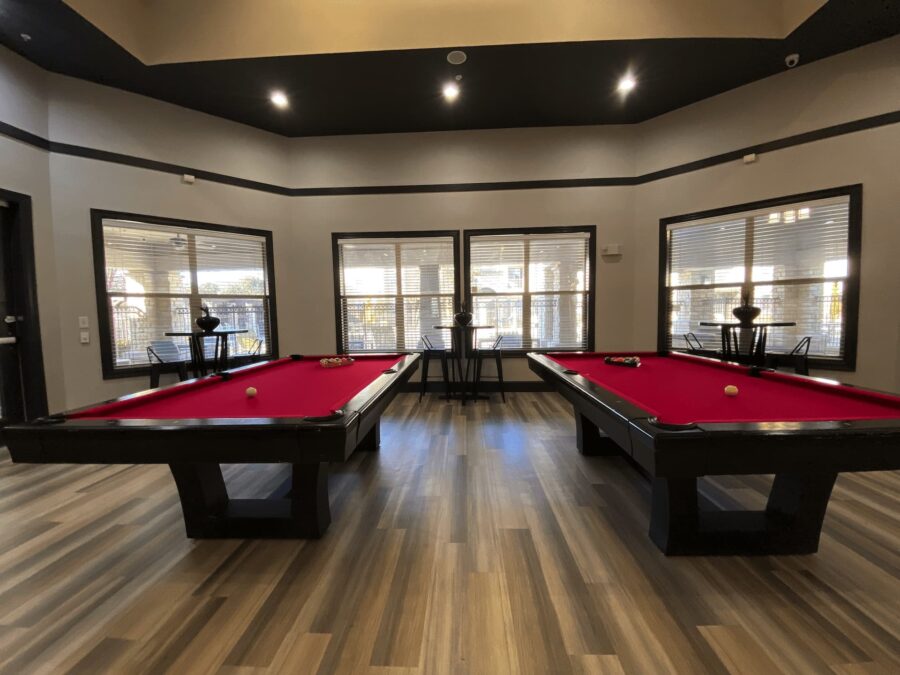 clubhouse with pool tables at forum at denton station apartments